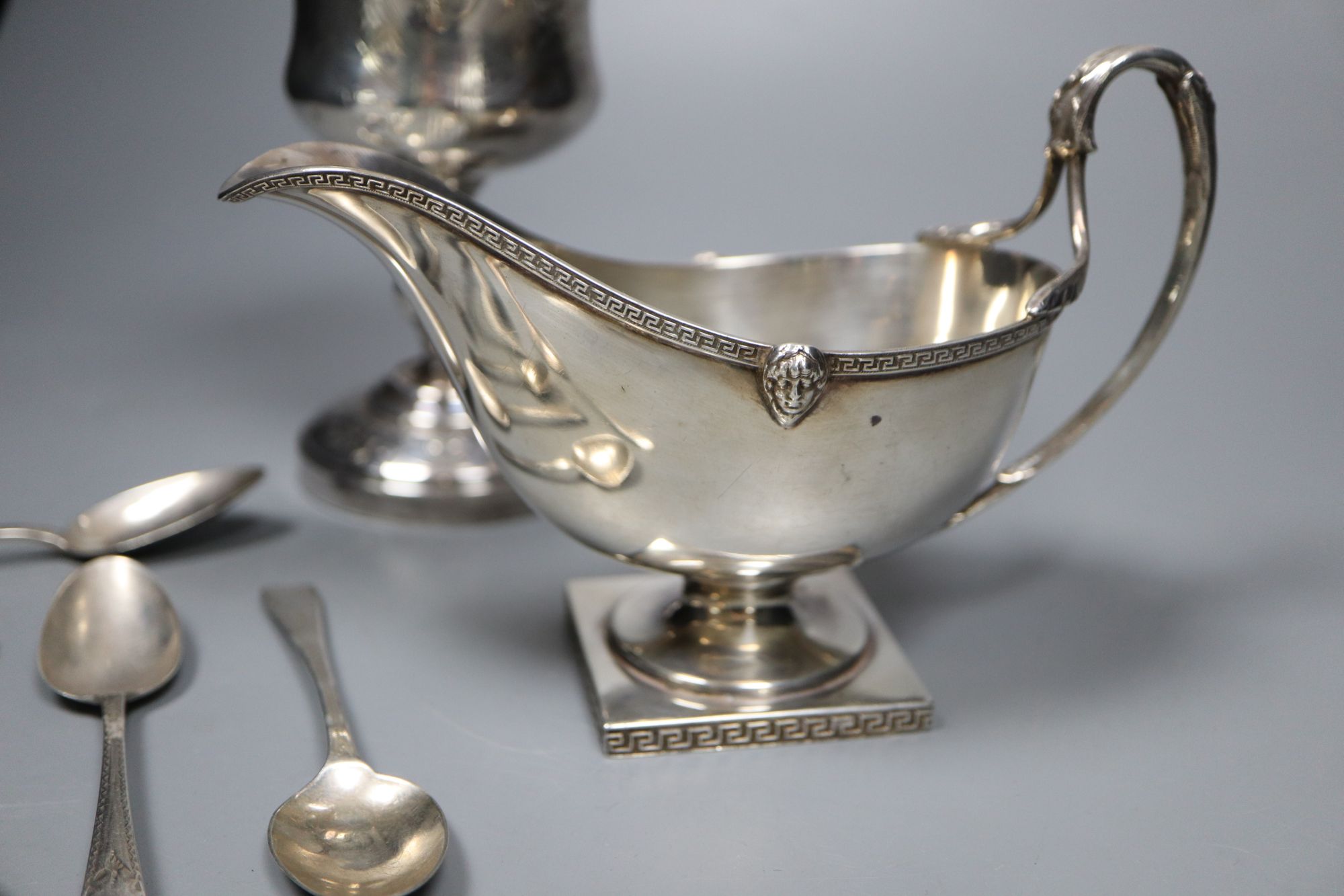 A George V silver sauceboat, a French white metal goblet(repaired) and seven assorted 19th century silver teaspoons,